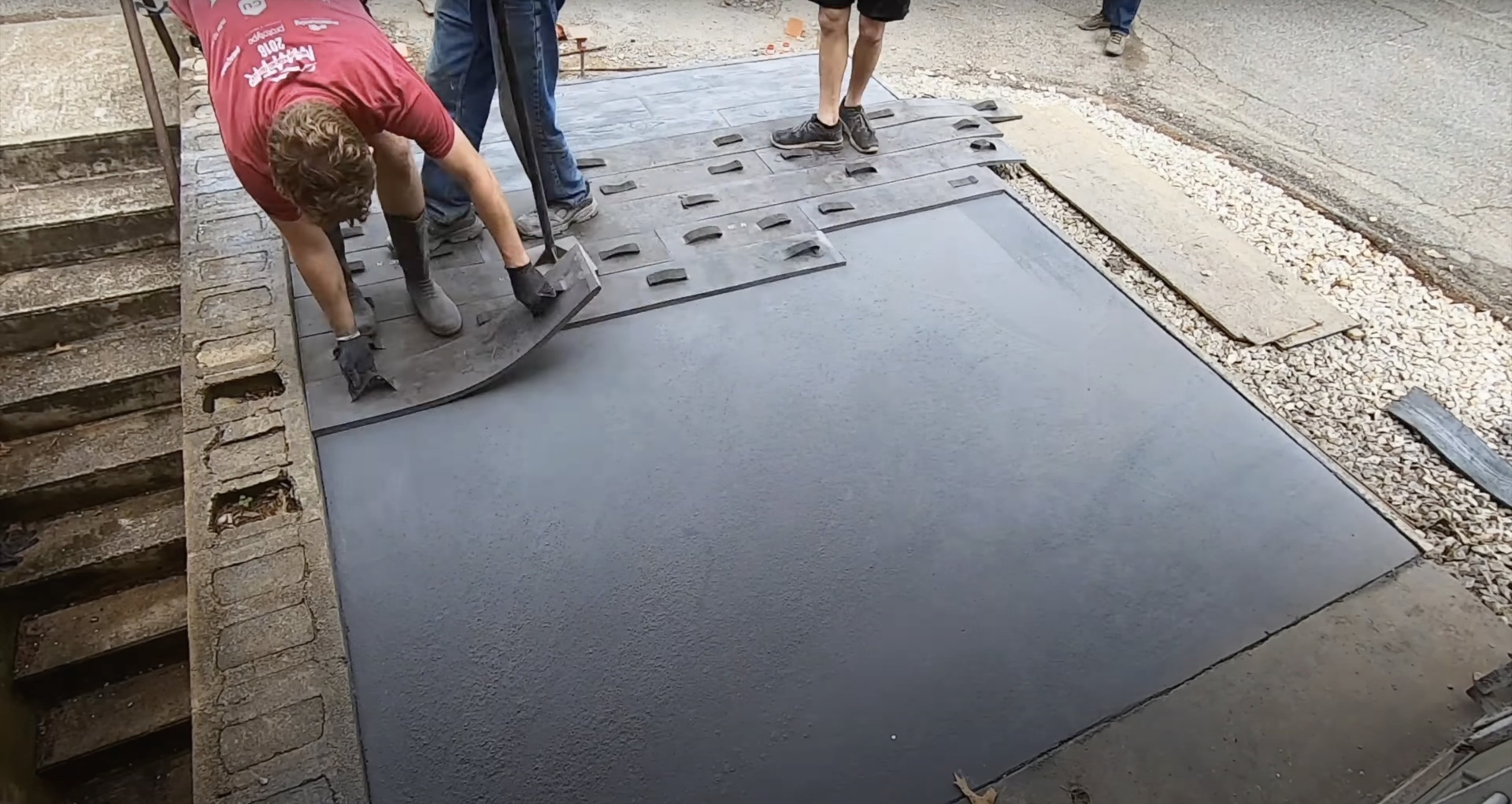 Stamped concrete installation process - decorative pattern application by Burien Concrete team Concrete crew applying stamped texture patterns to fresh concrete surface using professional stamping tools