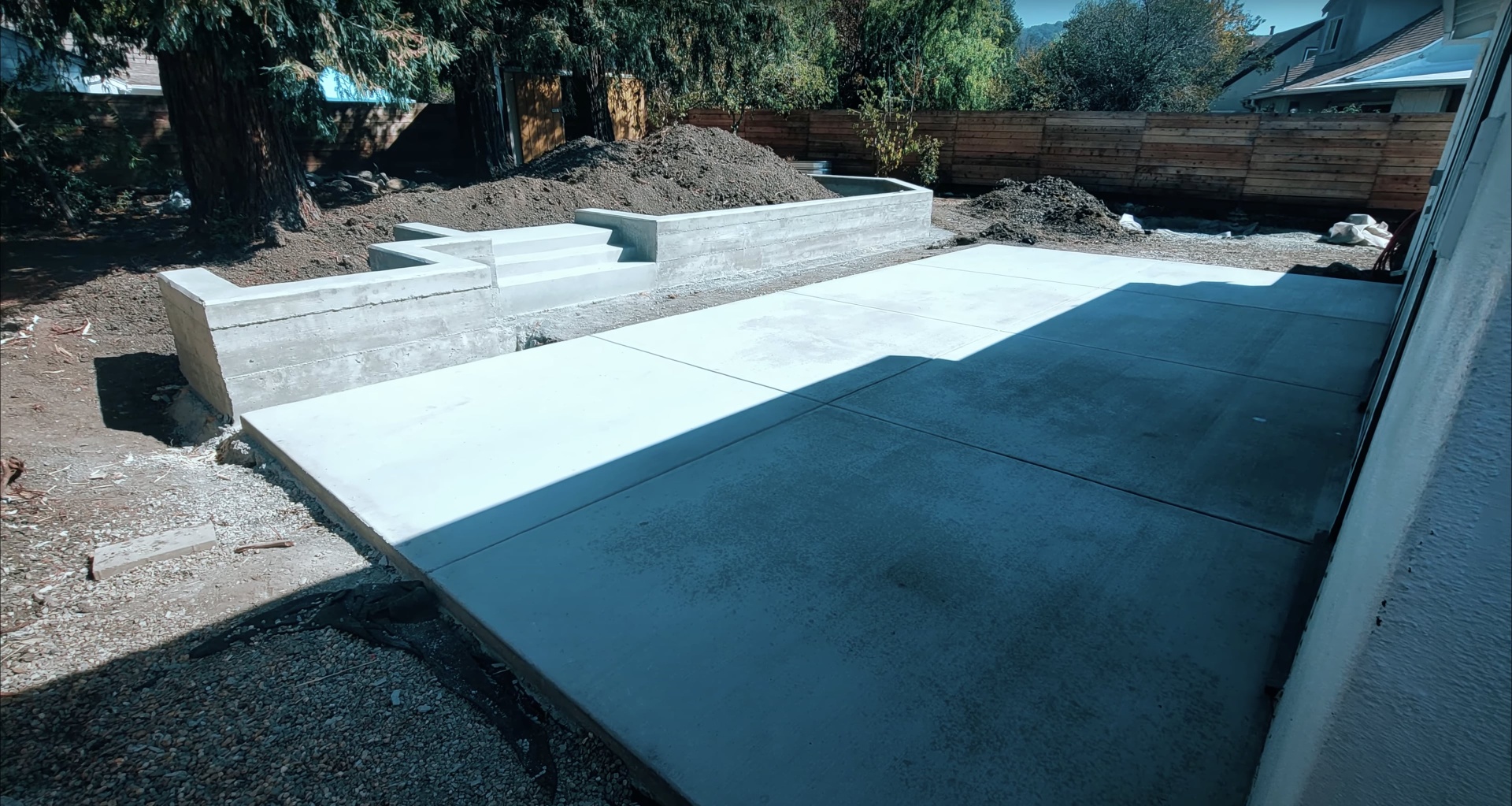 Concrete patio and retaining wall system - outdoor living space by Burien Concrete Modern concrete patio and retaining wall system creating multi-level outdoor living space