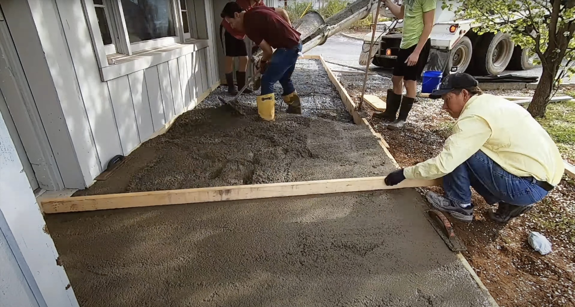 Professional concrete pouring services by Burien Concrete team Concrete crew pouring fresh concrete for residential driveway construction in Burien